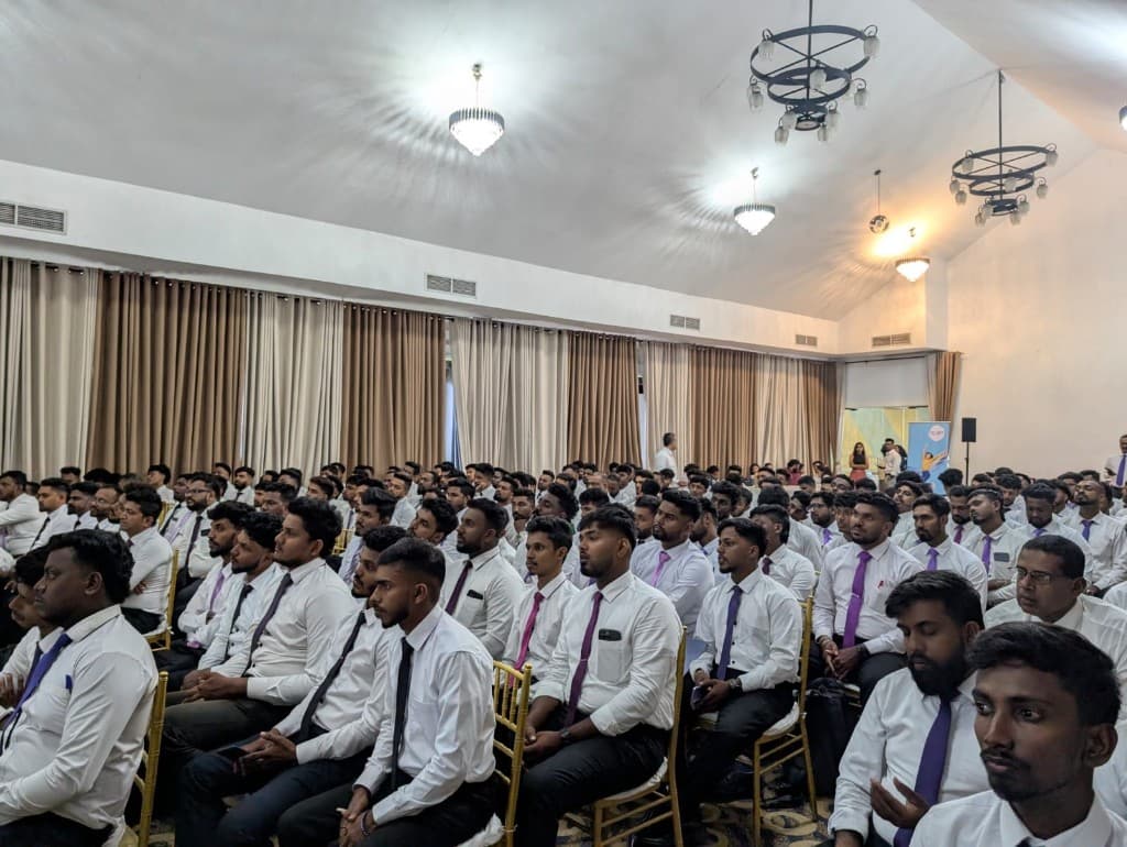 Large group of Bellose sales representatives seated at a company meeting